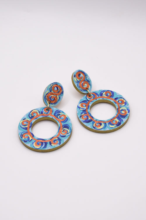 Pair of blue and orange earrings on a white background