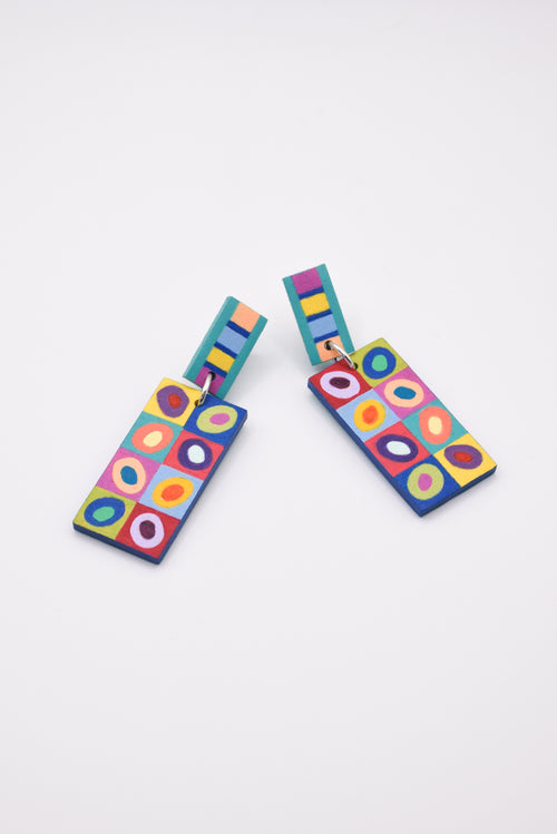 Colorful geometric patterned earrings on a white background