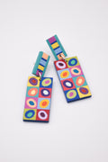 Hand-painted wooden colorful geometric patterned earrings on a white background.