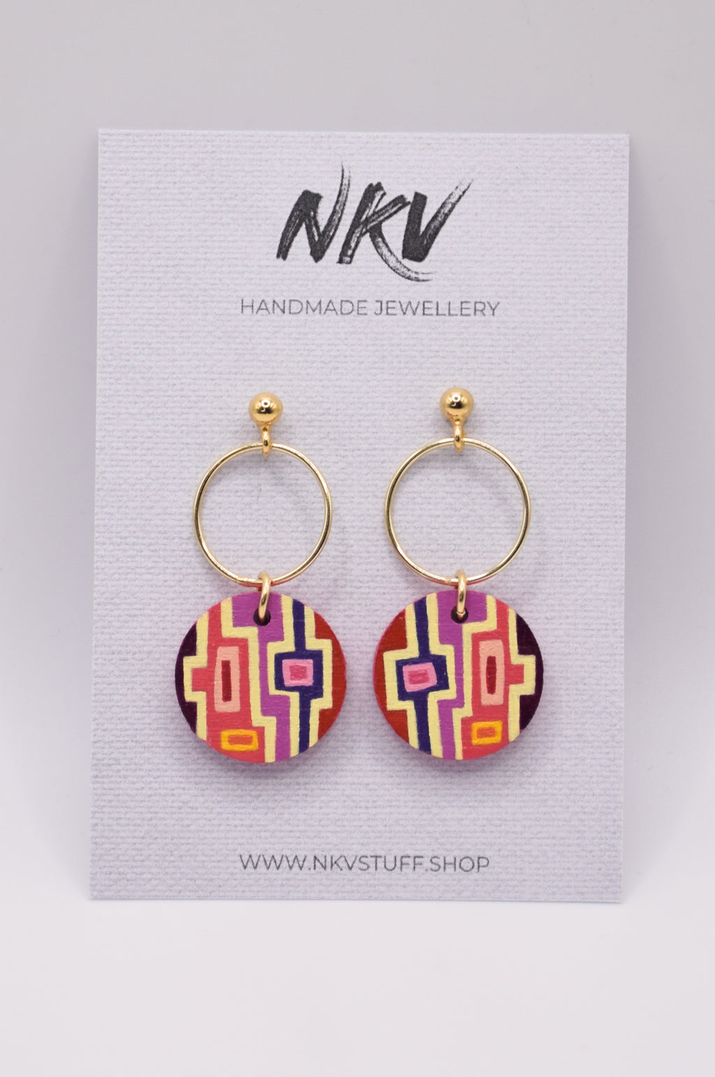Pair of geometric patterned earrings with gold hoops on a card with 'NKV Handmade Jewellery' branding.