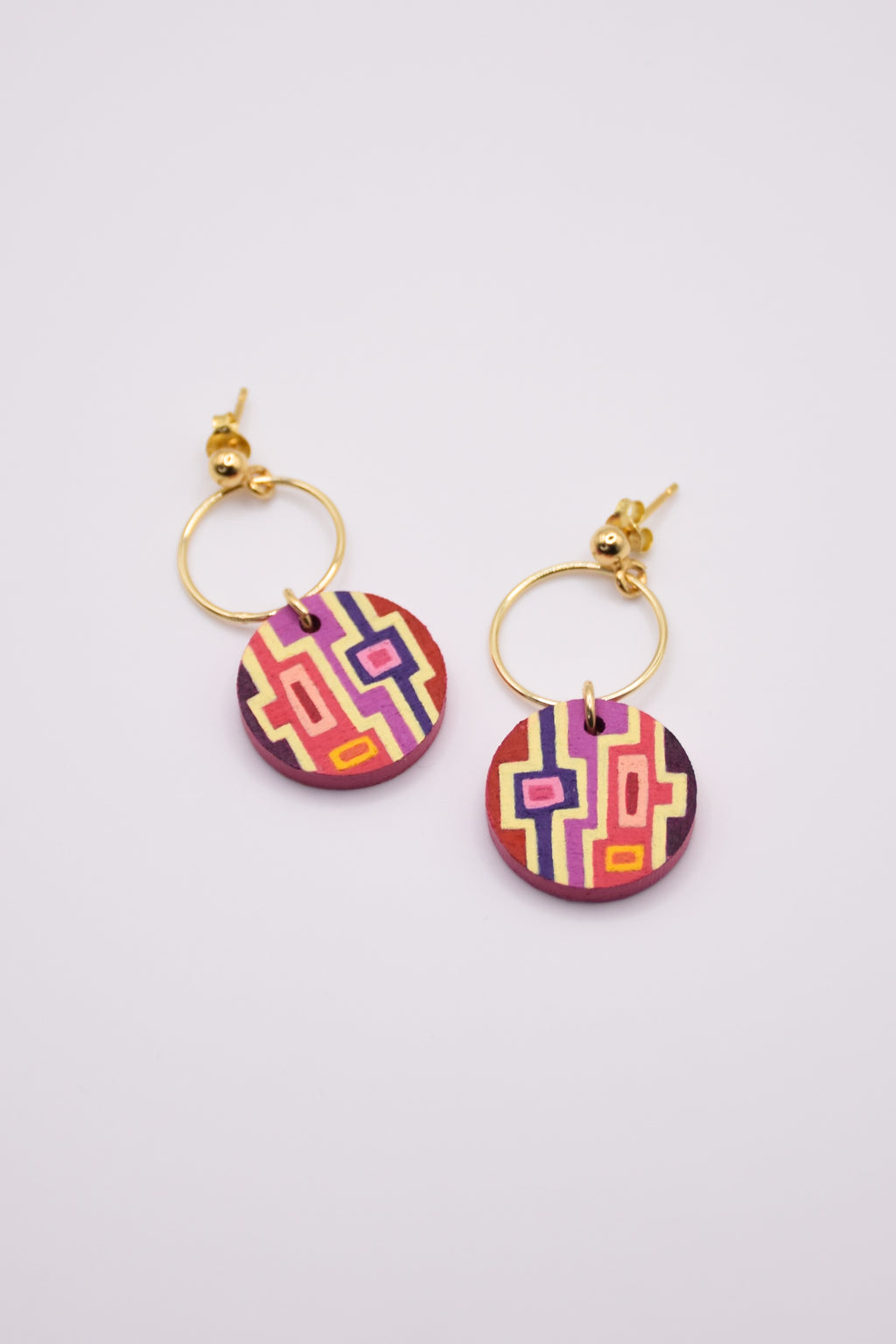 Colorful geometric patterned hand-painted earrings with gold hoops